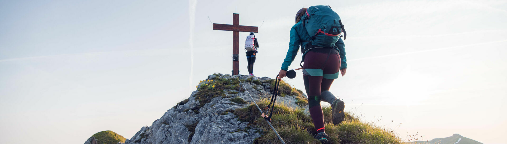 Rosskopf via ferrata Two women who are enthusiastic about mountain sports enjoy the morning atmosphere at the Rosskopf via ferrata in the Rofan mountains.