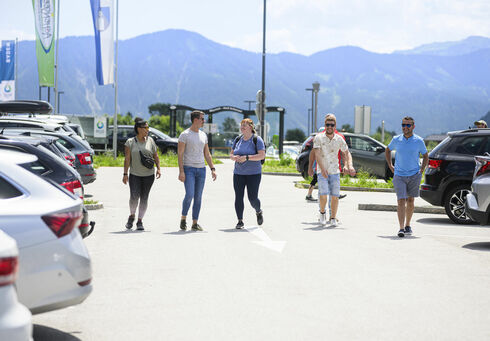 Achensee parking card A group of friends going to their cars in the car park of the Atoll Achensee.