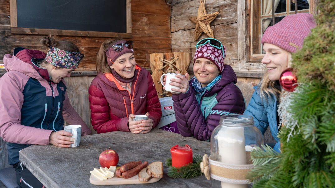 Refreshments in the Karwendel valleys A group of friends enjoy tea and a snack on the terrace of a mountain hut.