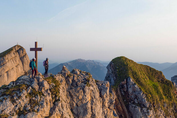 Rosskopf via ferrata Two women who are enthusiastic about mountain sports enjoy the morning atmosphere at the Rosskopf via ferrata in the Rofan mountains.