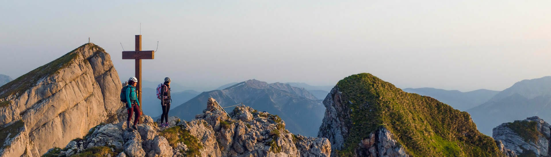 Rosskopf via ferrata Two women who are enthusiastic about mountain sports enjoy the morning atmosphere at the Rosskopf via ferrata in the Rofan mountains.