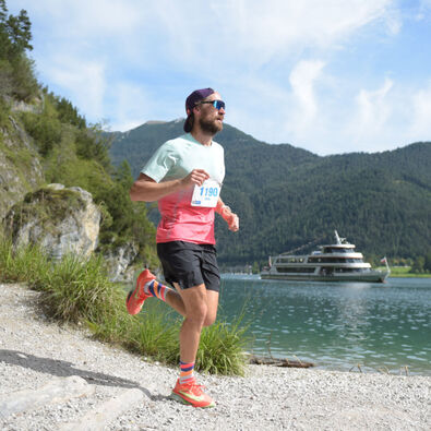 Achensee Run A participant on the trail route of the Achensee Run. The Achensee boat service can be seen in the background.