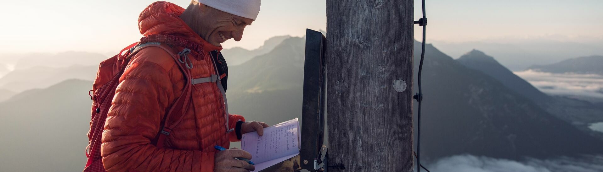 Summit book entry on the Seekarspitze in the Karwendel mountains A trail runner makes a summit book entry on the Seekarspitze in the Karwendel mountains.