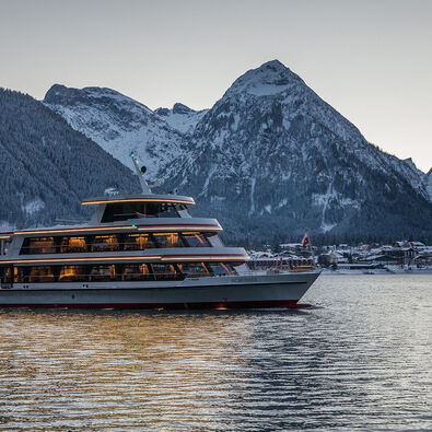 Achenseeschifffahrt in the evening The MS Achensee cruising over Lake Achensee on a winter evening. In the background of this photo is the village of Pertisau and the Karwendel mountains.