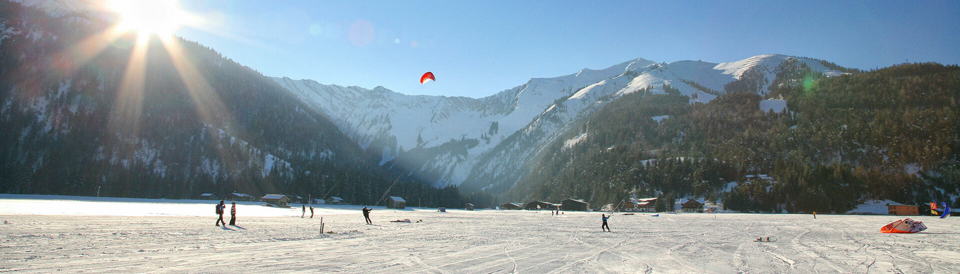 Snowkiting in Achenkirch am Achensee The winter version of kitesurfing is an exhilarating outdoor activity. Surfing over the snow with a kite is a must-do adventure for every sports enthusiast.