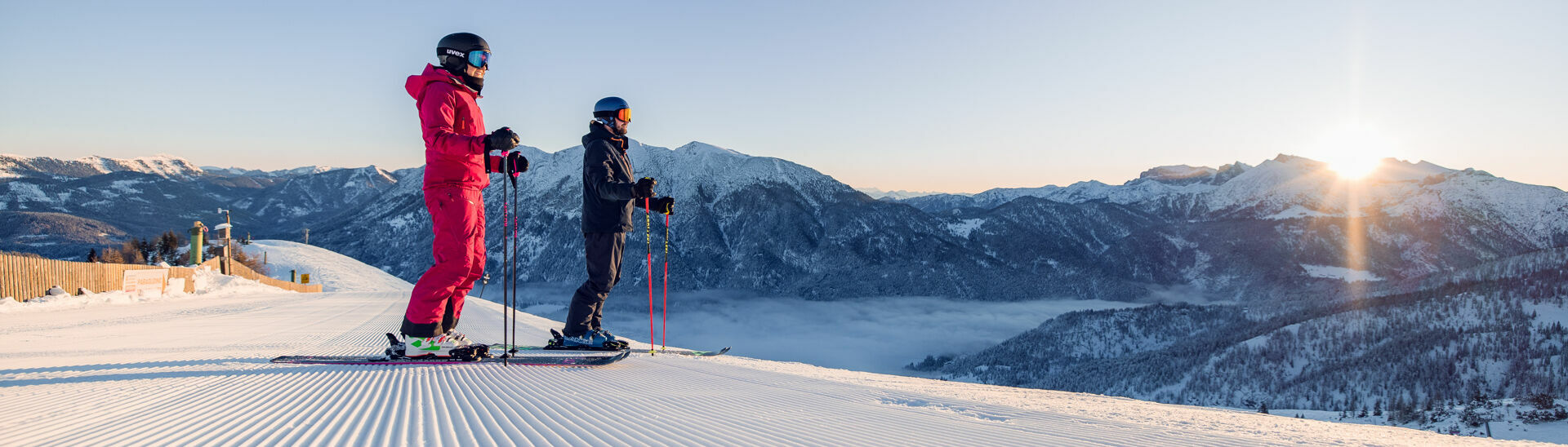 Downhill skiing in Achenkirch am Achensee Two skiers enjoy a day of skiing in brilliant sunshine in the Hochalmlifte Christlum ski area in Achenkirch am Achensee.