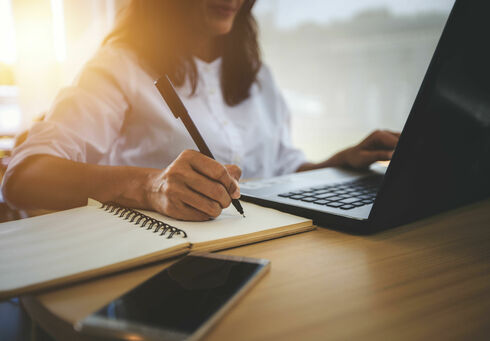 Online German courses & more This photo captures a woman working from home on her laptop.