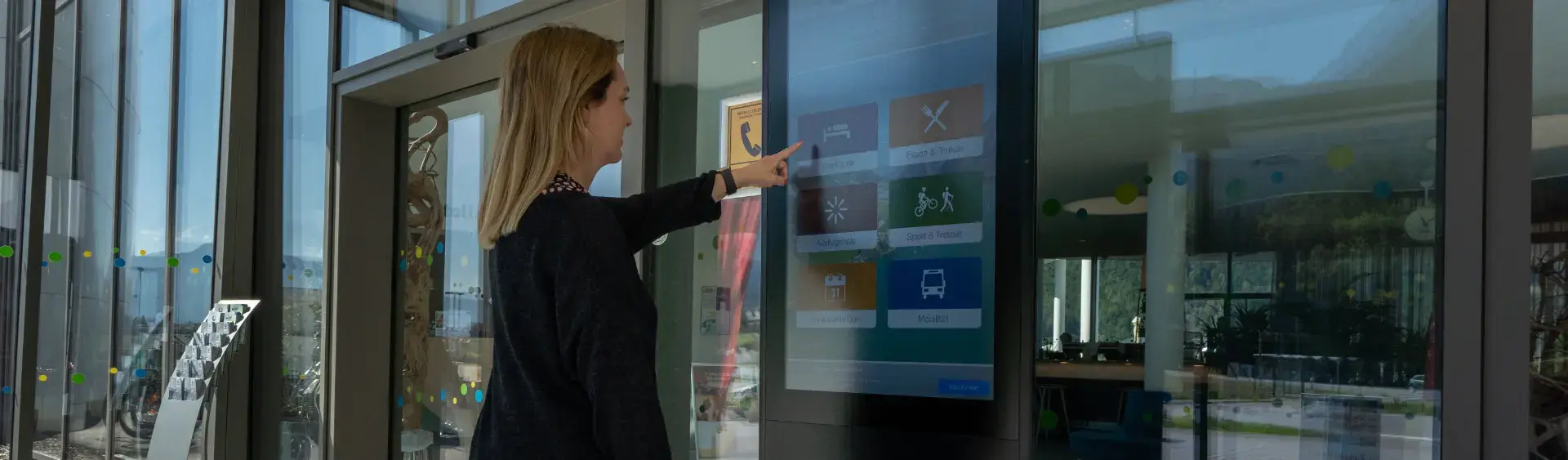 Infoterminals at Lake Achensee A woman gets information about the Achensee region at the information terminal in the Atoll Achensee.