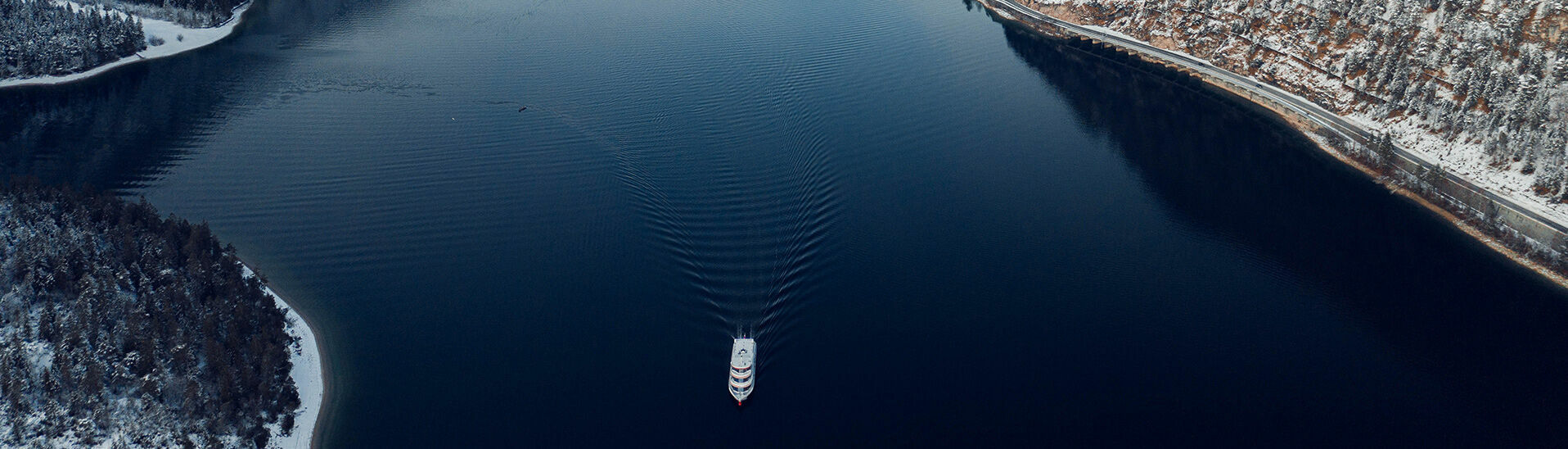 View of Lake Achensee View of Lake Achensee and one of the Achensee ships in winter, the village of Pertisau and the snow-covered Karwendel mountains.