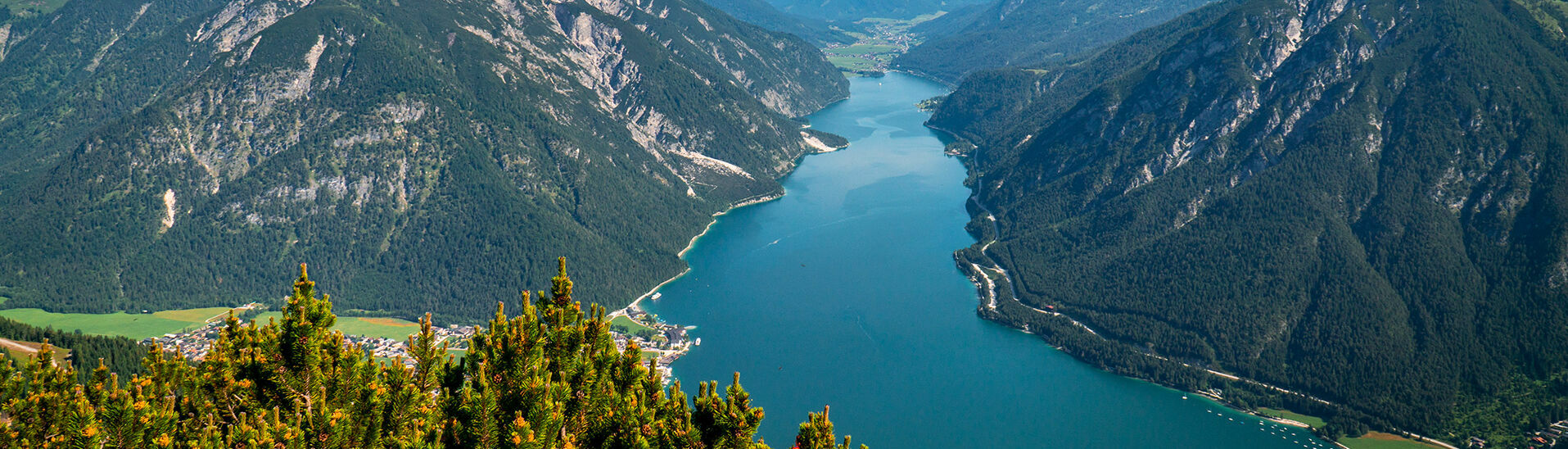 View from the Bärenkopf over Lake Achensee The Bärenkopf in the Nature Park Karwendel affords spectacular views of Lake Achensee and its surrounding villages.