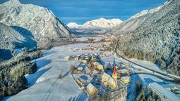 wintry view of Eben and the Notburga Church with the Notburga Museum (to the left of the church)